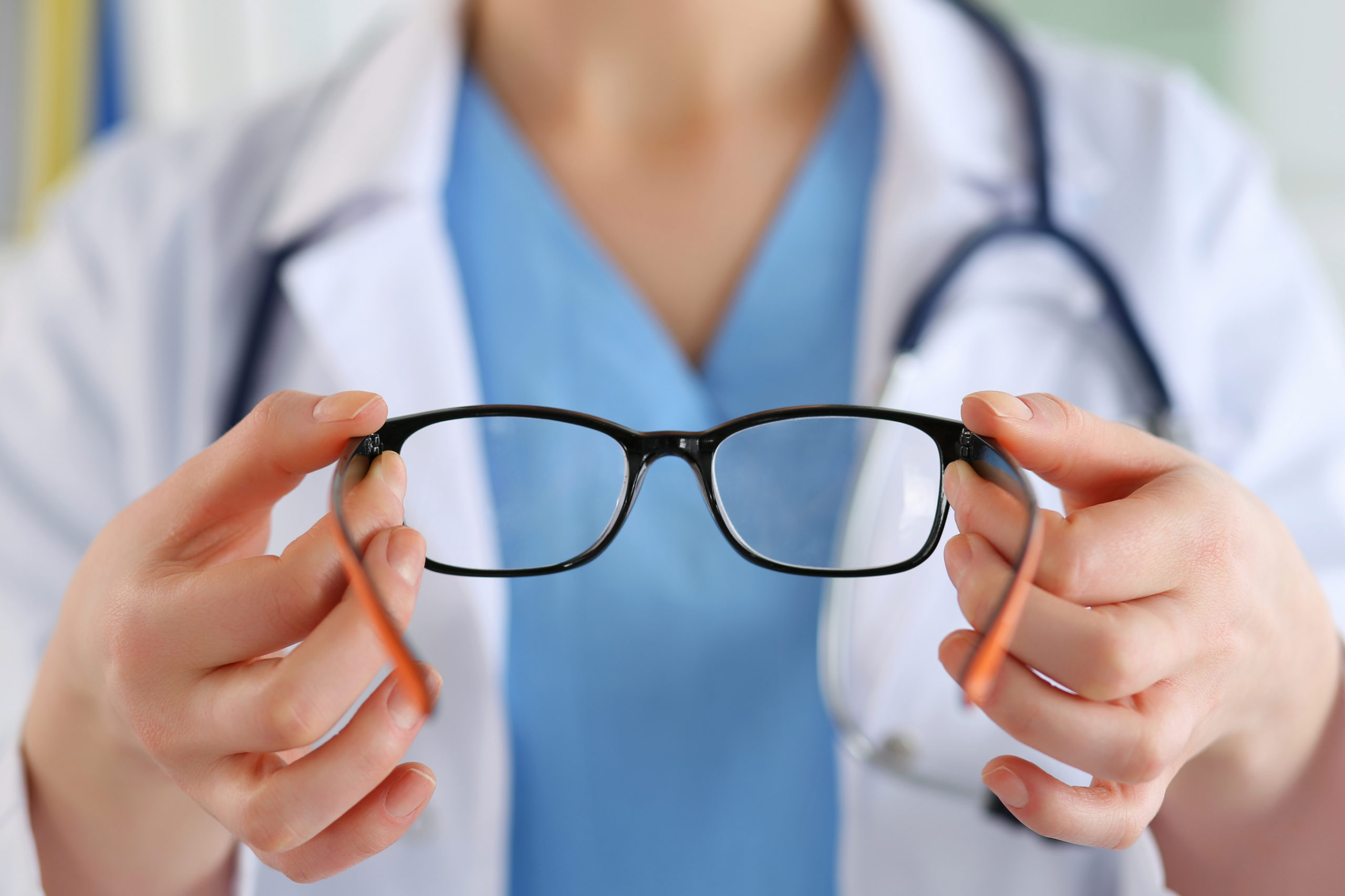 eye doctor holding glasses
