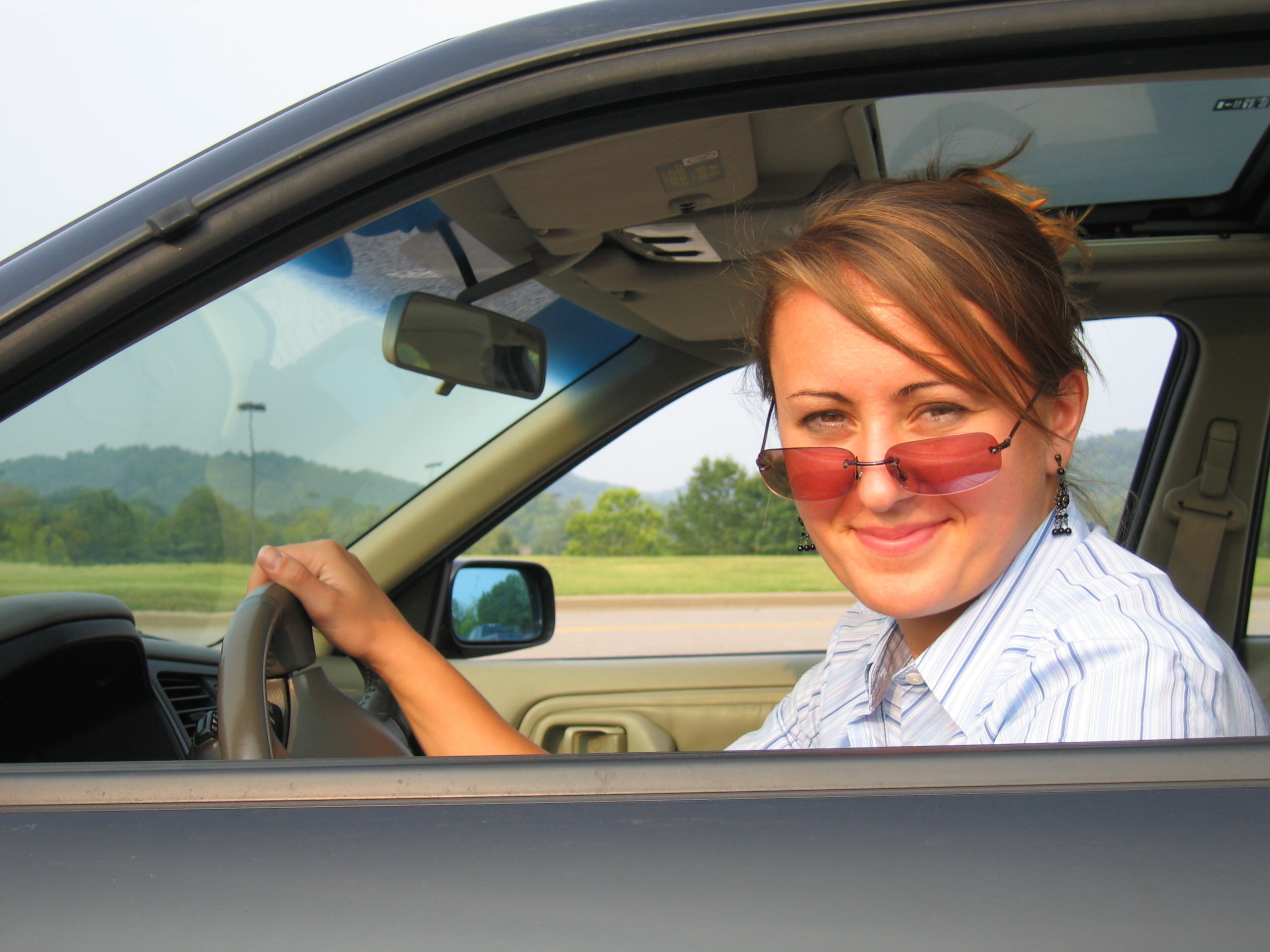 woman driving wearing sunglasses