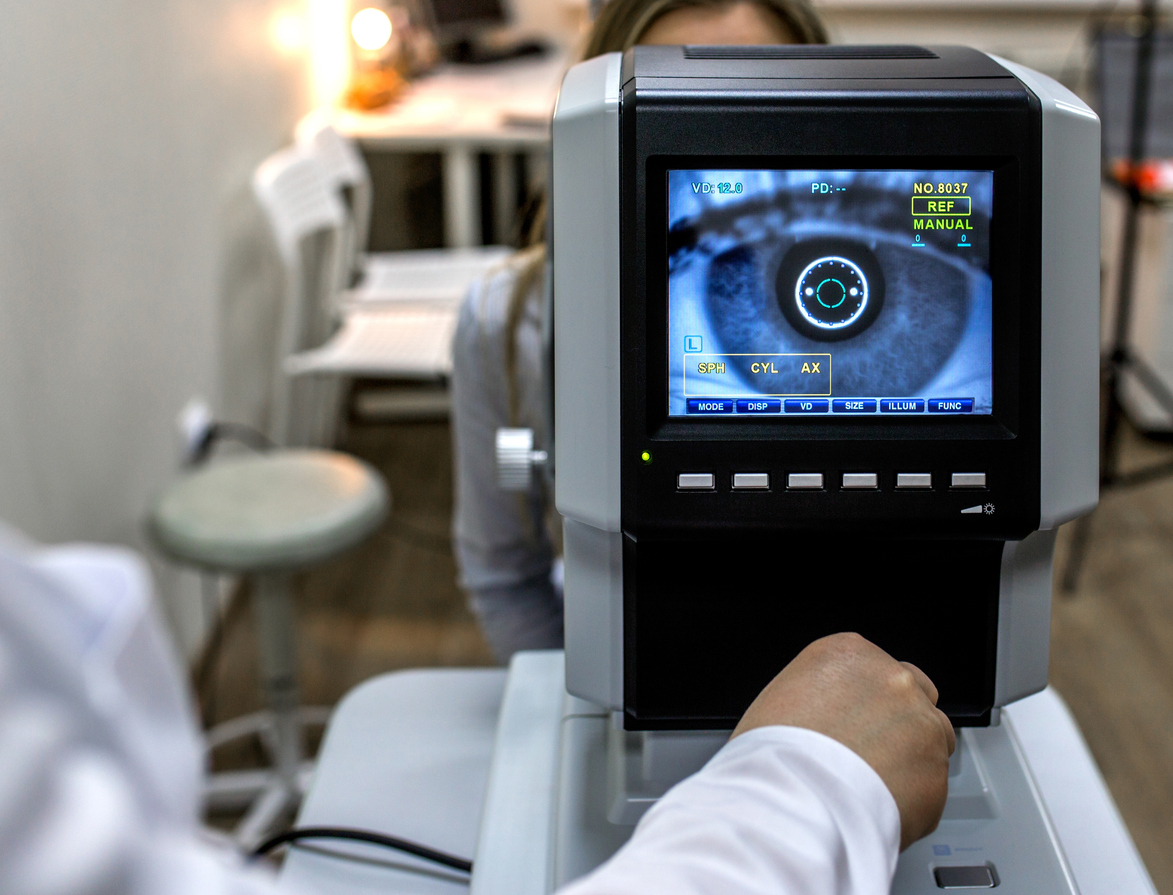 optometrist examining female patient in ophthalmology clinic