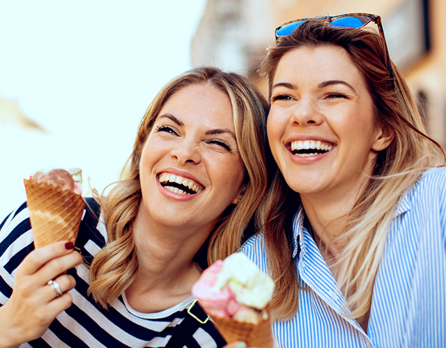 Two Denver LASIK eye surgery patients laughing eating ice-cream