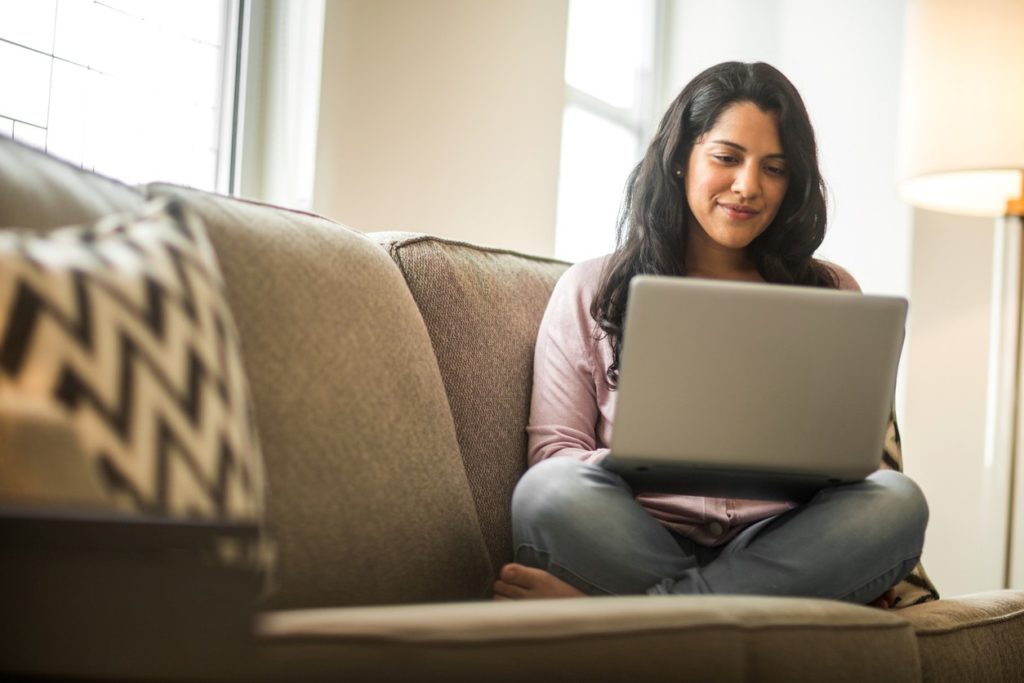 woman-working-on-laptop-on-sofa