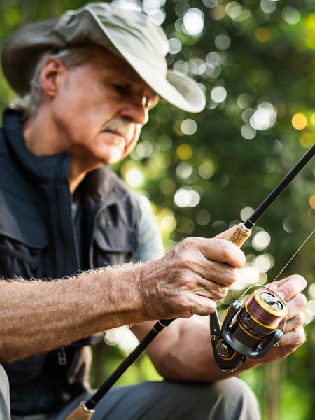 older man enjoying fishing after cataract surgery in Glenwood Springs Colorado